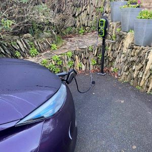 electric car charge point plugged in to hybrid