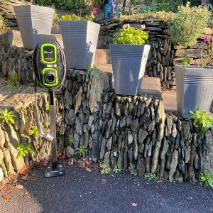 electric car charge point by plant pots